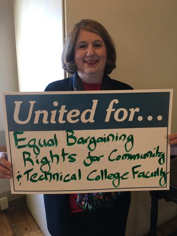 Carla holds a sign for equal bargaining rights for community and technical college faculty